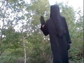 Outdoor In niqab showing nylon legs.